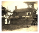 Edwardian mother and child outside old house